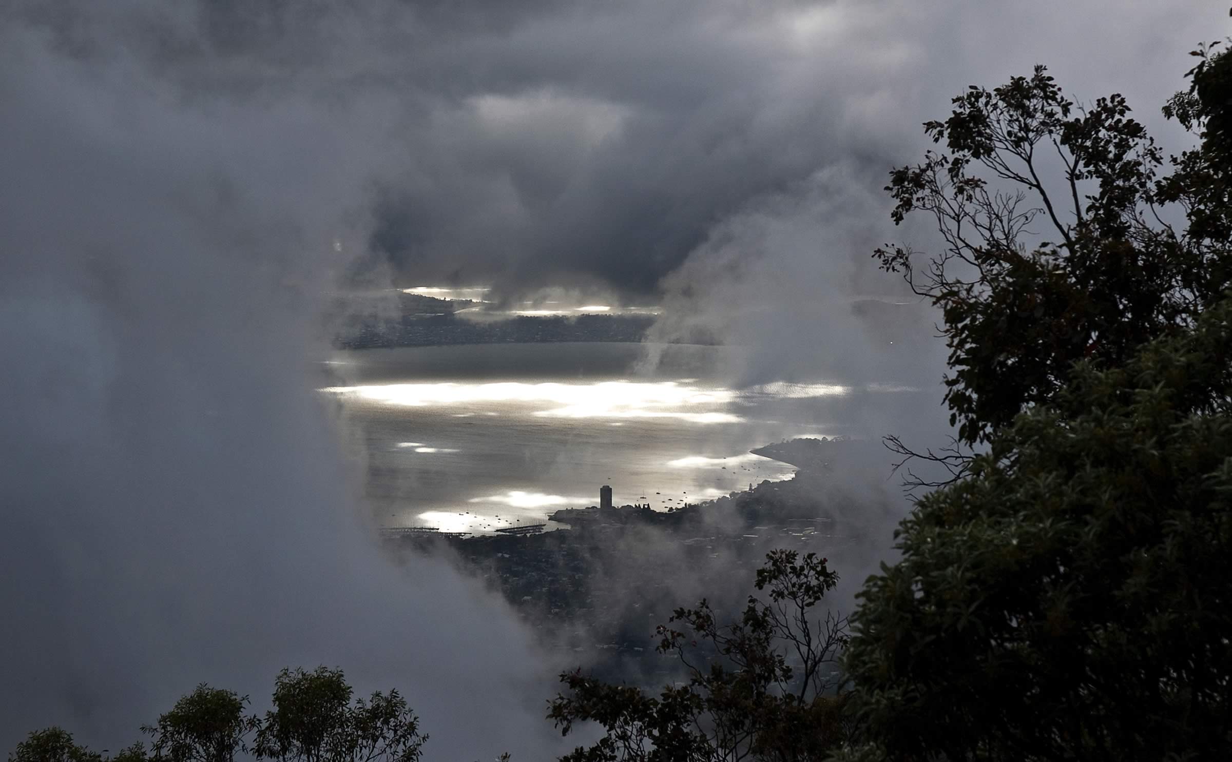 Sandy Bay glimpsed through a break in the clouds from kunanyi / Mount Wellington. Image: Steve Lacy
