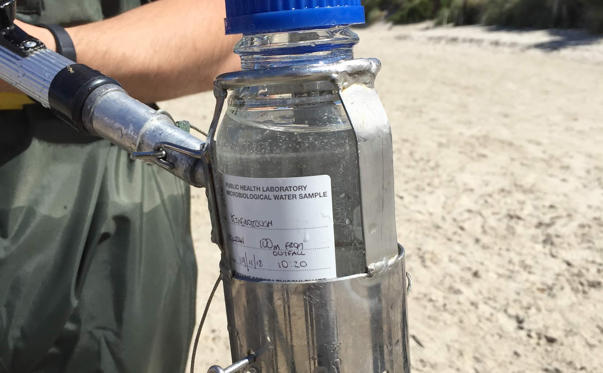 Taking a water sample from the beach.
